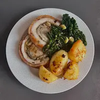 Porchetta with roast potatoes and cavolo nero